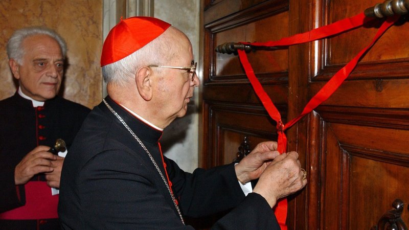 Cardinal Eduardo Martinez Somalo seals the door to St. John Paul II's apartment at the Vatican April 12, 2005. Cardinal Martinez, the former "camerlengo" or chamberlain of the Holy Roman Church and former prefect of the congregation for religious, died Aug. 10, 2021, in his Vatican apartment at age 94. (CNS photo/L'Osservatore Romano)