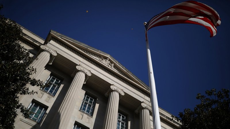 An American flag waves outside the Department of Justice Building in Washington Dec. 2, 2020. (CNS photo/Tom Brenner, Reuters)