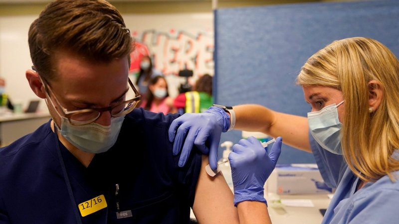 Fourth-year medical student Anna Roesler administers the Pfizer-BioNTech COVID-19 vaccine at Indiana University Health Methodist Hospital in Indianapolis Dec. 16, 2020. The Supreme Court announced Aug. 12, 2021, that Indiana University can require students to be vaccinated against the coronavirus disease. (CNS photo/Bryan Woolston, Reuters)