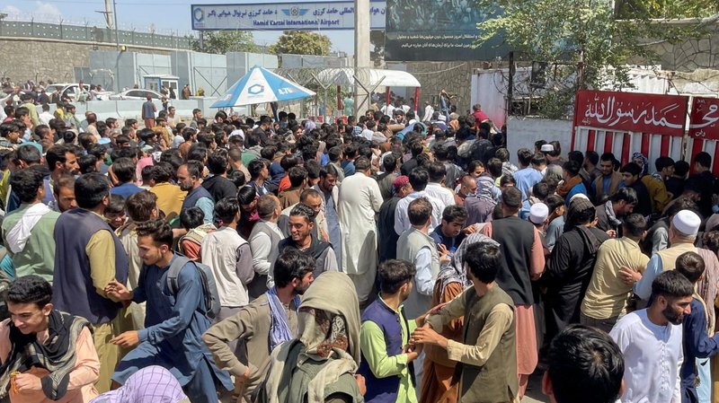 People try to get into Hamid Karzai International Airport in Kabul, Afghanistan, Aug. 16, 2021. During his Angelus address Aug. 15, Pope Francis expressed his concern for Afghanistan amid the Taliban's control of the country. (CNS photo/Reuters)