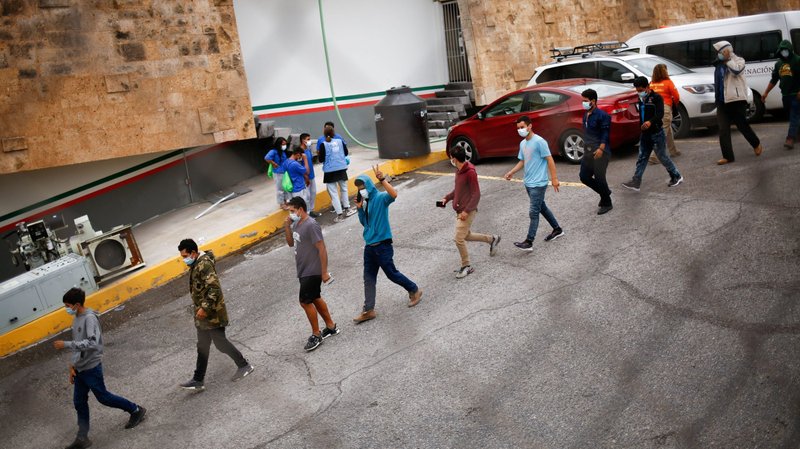 Migrants in Ciudad Juarez, Mexico, who were expelled from the U.S and sent back to Mexico under Title 42, line up outside the National Institute of Migration building Aug. 13, 2021. U.S. District Judge Matthew J. Kacsmaryk in Amarillo, Texas, ruled the same day that the Biden administration must revive a Trump-era policy requiring immigrants seeking asylum to wait in Mexico while their applications are processed. (CNS photo/Jose Luis Gonzalez, Reuters)