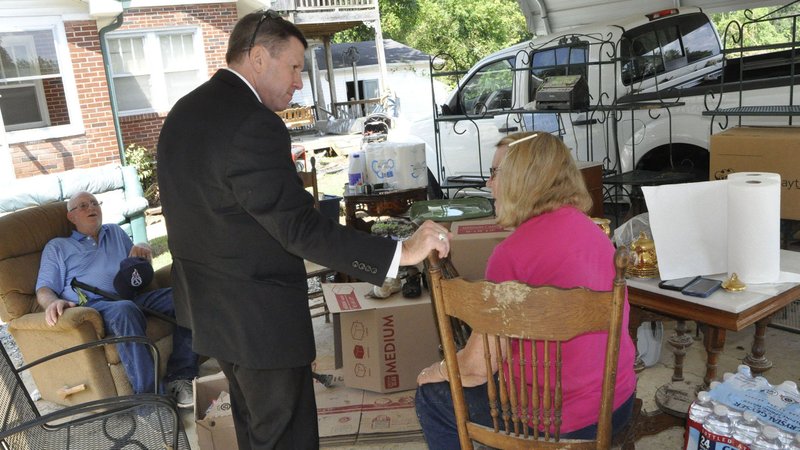 Bishop J. Mark Spalding of Nashville, Tenn., visits with James and Patsy Bradley of Waverly, Tenn., Aug. 24, 2021. The parishioners of St. Patrick Catholic Church in McEwan, Tenn., said their home was destroyed by the Aug, 21 flood waters, and that one car was lost and their truck was disabled. CNS photo/Katie Peterson, Tennessee Register)