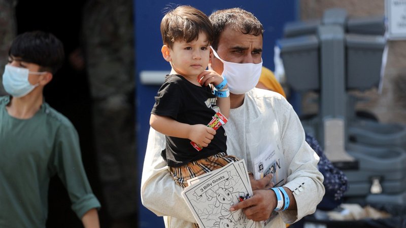 Families depart from a processing center for Afghanistan evacuees at the Dulles Expo Center near Dulles International Airport in Chantilly, Va., Aug. 25, 2021. (CNS photo/Jonathan Ernst, Reuters)