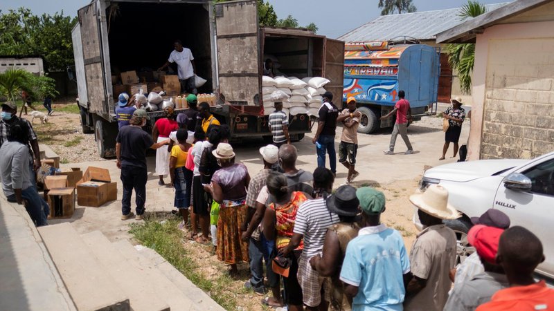 Earthquake victims wait in line for food provided by the World Food Program at a school in Port Salut, Haiti, Aug. 24, 2021. (CNS photo/Ricardo Arduengo, Reuters)