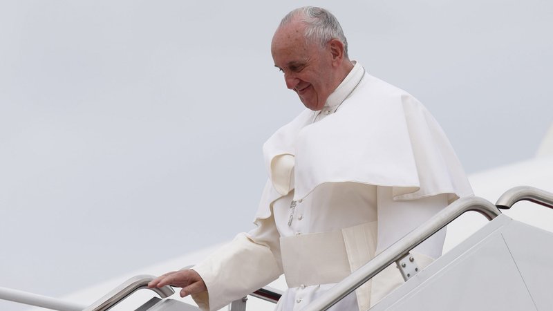 Pope Francis walks from the papal plane as he arrives at an airfield during a 2015 foreign trip. (CNS photo/Paul Haring)