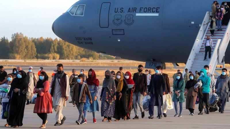 Afghan citizens evacuated from Kabul disembark from a U.S Air Force transport plane as they arrive at Naval Station Rota Air Base in Rota, Spain, Aug. 31, 2021. (CNS photo/Jon Nazca, Reuters)