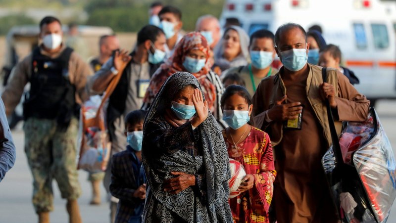 Afghan citizens evacuated from Kabul disembark from a U.S Air Force transport plane as they arrive at Naval Station Rota Air Base in Rota, Spain, Aug. 31, 2021. (CNS photo/Jon Nazca, Reuters)