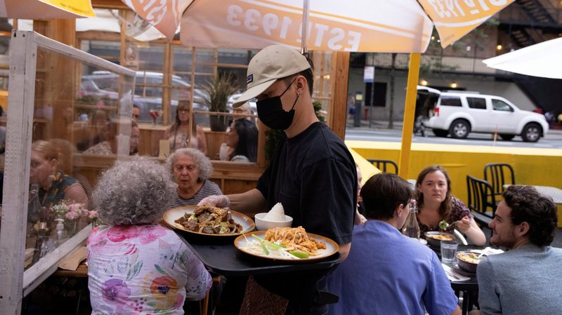 People eat at a restaurant in New York City Aug. 3, 2021, amid the coronavirus pandemic. Labor Day is Monday, Sept. 6. (CNS photo/Caitlin Ochs, Reuters)
