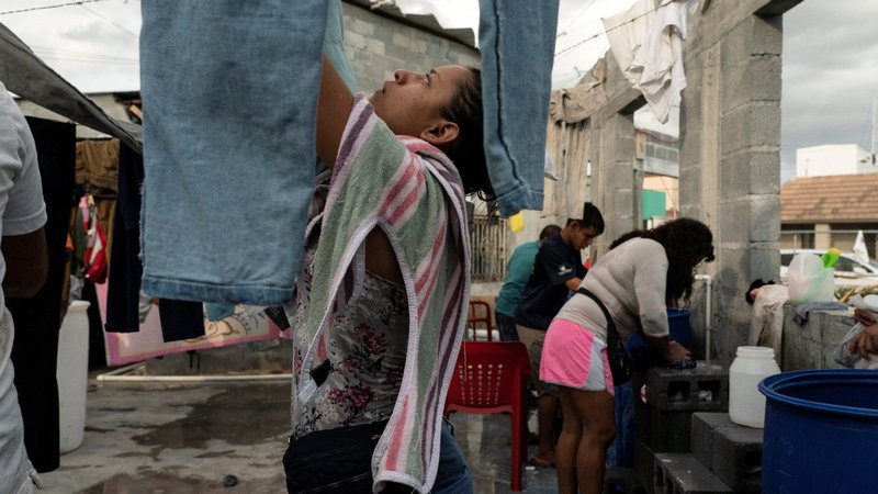 Asylum-seeking migrants from Central America do their laundry in the public square of Reynosa, Mexico, near the Texas border, Aug. 27, 2021. The number of migrants arriving at the U.S.-Mexico border has reached levels not seen in two decades, and a Vatican official has urged Mexican bishops to make ministering to migrants a priority. (CNS photo/Go Nakamura, Reuters)
