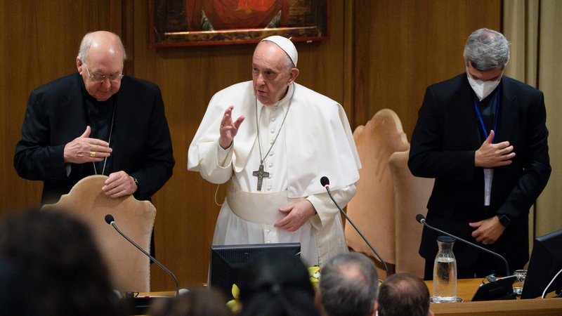 Pope Francis gives his blessing Sept. 16, 2021, at the end of a meeting in the Vatican synod hall with members of lay movements. The pope was joined by Cardinal Kevin J. Farrell, left, and Schonstatt Father Alexandre Awi Mello, right, respectively president and secretary of the Dicastery for Laity, the Family and Life. Pope Francis spoke to people taking part -- online and onsite in Rome -- in a meeting organized by the dicastery, focusing on the issue of responsible governance in lay movements and associations. (CNS photo/Vatican Media)