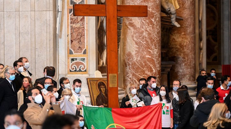 Young people from Portugal are pictured with the World Youth Day cross and their country's national flag following the cross' handover from their Panamanian peers at the end of Pope Francis' Mass Nov. 22, 2020. Pope Francis chose several verses that reflect on the call to "arise" and "stand up" as the themes for World Youth Day 2020-2022 in dioceses around the world, leading up to the international gathering in Lisbon, Portugal, in 2023. (CNS photo/Vincenzo Pinto, Reuters pool)