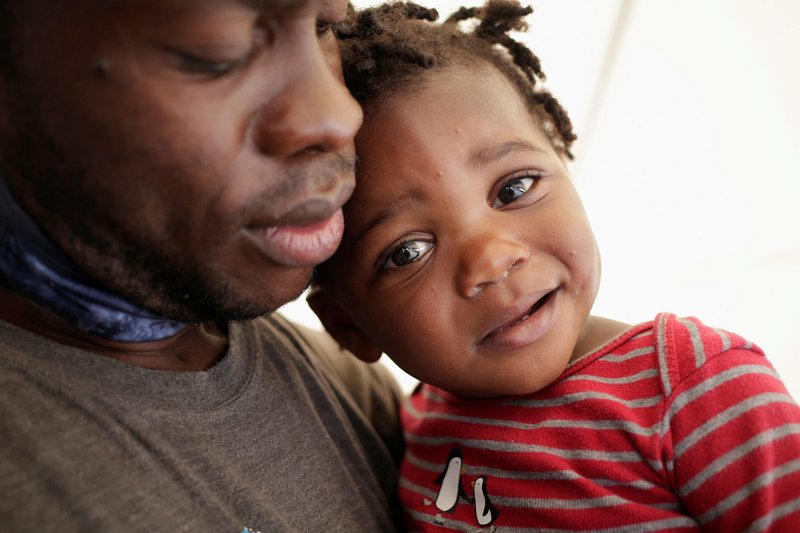 A Haitian migrant and child seeking refuge in the U.S. are pictured outside a shelter in Monterrey, Mexico, Sept. 28, 2021. (CNS photo/Daniel Becerril, Reuters)