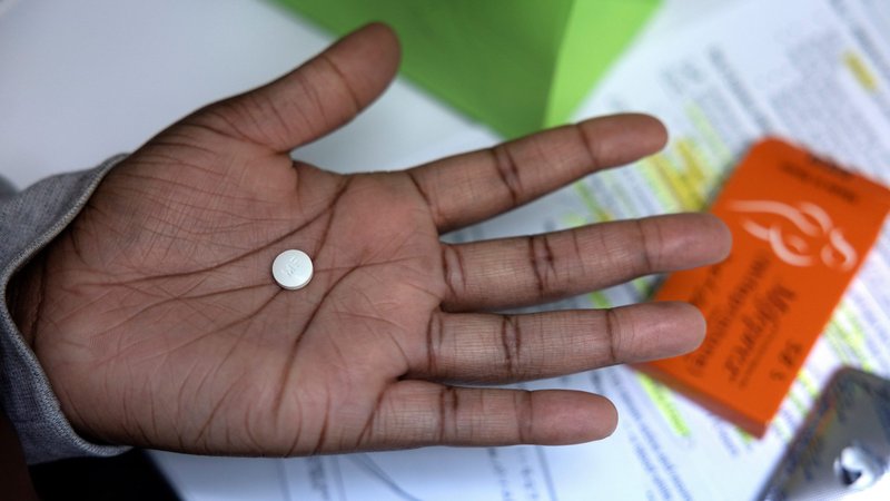 A patient at Houston Women's Reproductive Services in Texas holds the abortion-inducing medication she is about to take Oct. 1, 2021, as the first step in a medical abortion. (CNS photo/Evelyn Hockstein, Reuters)