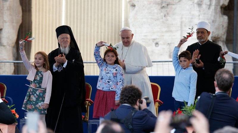 Ecumenical Patriarch Bartholomew of Constantinople, Pope Francis and Egyptian Sheikh Ahmad el-Tayeb, grand imam of Al-Azhar, look on as children wave olive branches during a meeting in front of the Colosseum in Rome Oct. 7, 2021. The meeting was held to plead and pray for peace. (Paul Haring/CNS)