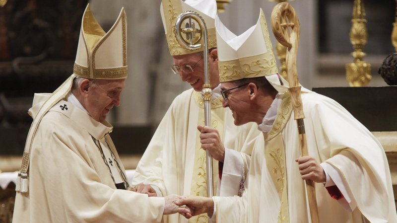 Pope Francis greets newly ordained Bishop Guido Marini, former master of liturgical ceremonies, and Archbishop Andrés Gabriel Ferrada Moreira, the secretary of the Congregation for Clergy, during an episcopal ordination Mass in St. Peter's Basilica at the Vatican Oct. 17, 2021. (CNS photo/Romano Siciliani, pool)