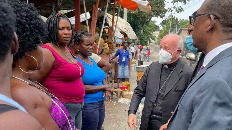 Archbishop Vincenzo Paglia, president of the Pontifical Academy for Life, meets residents of Port-au-Prince during his Oct. 17-19 visit to Haiti. In an article about his trip, Archbishop Paglia said Europe can no longer ignore the cries of the Haitian people. (CNS photo/courtesy Pontifical Academy for Life)