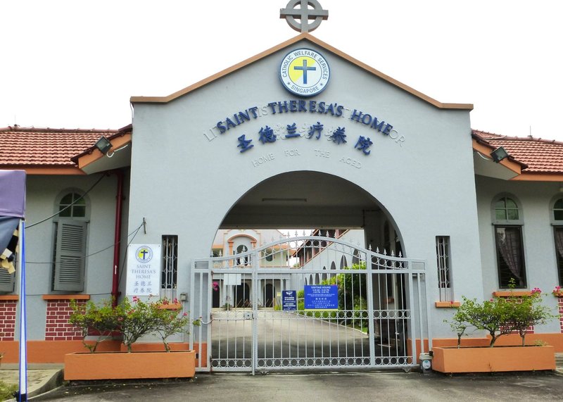The gatehouse at St. Theresa's Home in Singapore is seen Oct. 16, 2021. Behind the blue lettering, you can see words indicating this was a home run by the Little Sisters of the Poor. The buildings within are slated for conservation by the government. (Christopher Khoo/CNS)