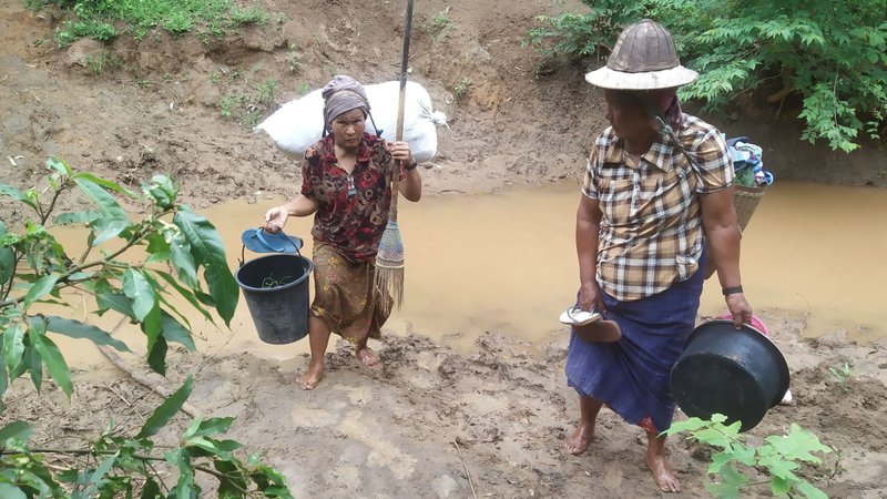 Villagers displaced by fighting in eastern Myanmar cross a river in Kayah state June 12, 2021. Myanmar's military has arrested seven workers from the Catholic Church's social arm Caritas (Karuna) who were on a mission to provide aid for internally displaced persons in Kayah. (CNS photo/Reuters)