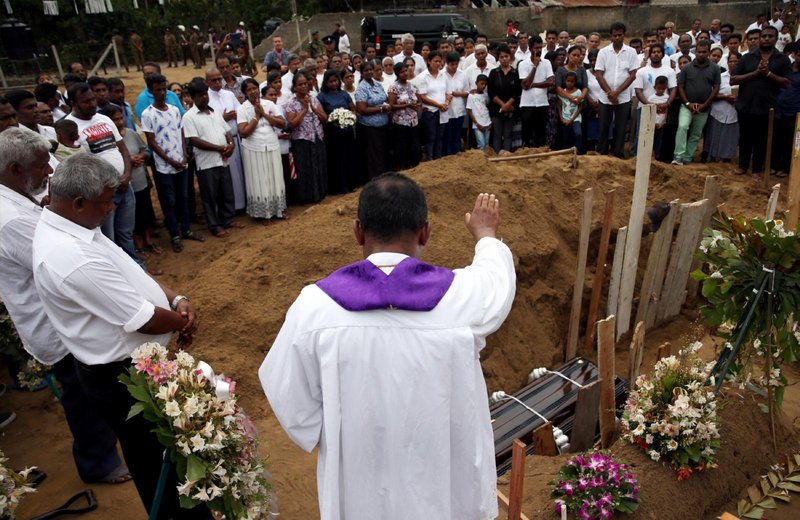A clergyman prays over the casket of 13-year-old Dhami Brindya during her burial in Negombo, Sri Lanka, April 25, 2019, four days after a string of suicide bomb attacks on churches and luxury hotels across the island. As an investigation into Easter 2019 bombings continues, Pope Francis expressed solidarity with the Sri Lankan Catholic Church, Cardinal Malcolm Ranjith of Colombo said Oct. 24, 2021. (CNS photo/Athit Perawongmetha, Reuters)
