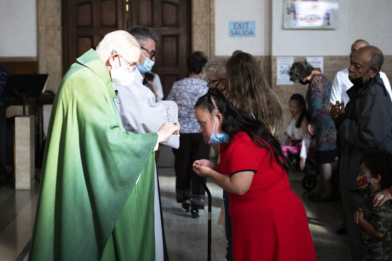 Archbishop Gomez distributes communion at the 35th annual Mass for FUERZA. (Victor Alemán)
