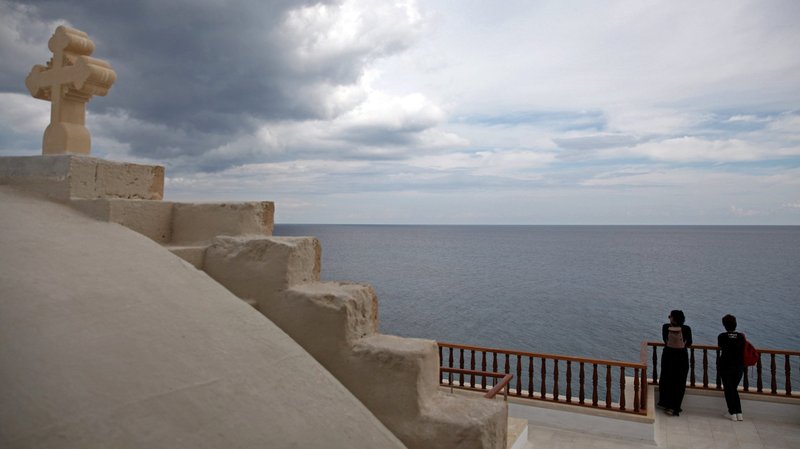Pilgrims look at the horizon at the Monastery of Apostolos Andreas in Karpasia, Cyprus, Nov. 7. (CNS photo/Yiannis Kourtoglou, Reuters)
