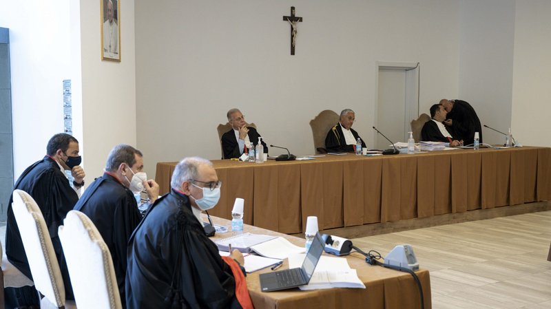 The judges of the Vatican City State criminal court -- Venerando Marano, Giuseppe Pignatone and Carlo Bonzano -- sit under a crucifix in a makeshift Vatican courtroom July 27, 2021, as the trial of 10 defendants in a financial malfeasance case begins. (CNS photo/Vatican Media)