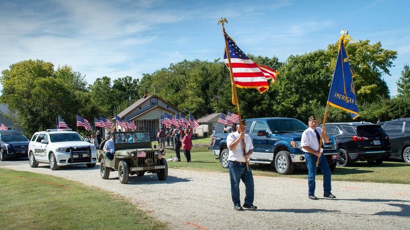 Veterans in Pilsen, Kan., walk in front of a motorcade for Father Emil J. Kapaun near near St. John Nepomucene Church Sept. 25, 2021. A candidate for sainthood, Father Kapaun died May 23, 1951, while ministering to prisoners of war during the Korean War. (Christopher M. Riggs/Catholic Advance, via CNS)