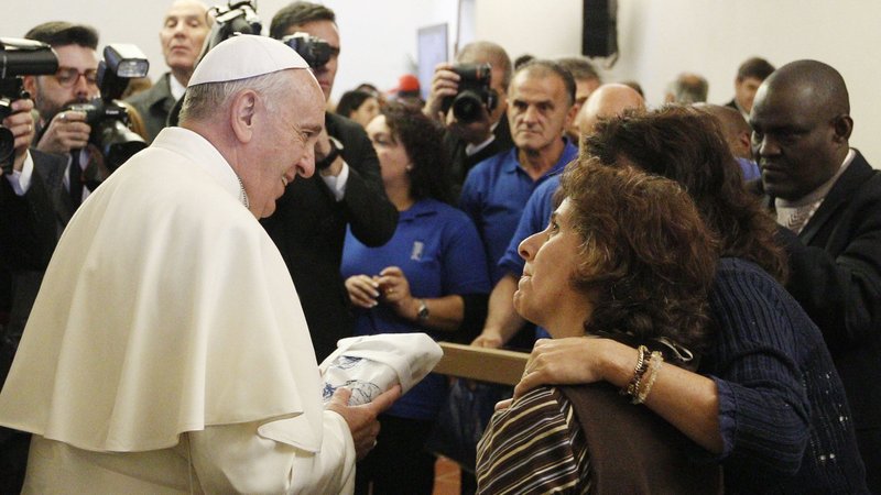 Pope Francis greets people during a meeting with the poor in the archbishop's residence in Assisi, Italy, in this Oct. 4, 2013, file photo. The pope will travel to Assisi Nov. 12 for a time of listening and prayer with 500 poor people from several countries. (CNS photo/Paul Haring)
