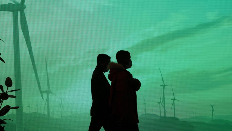 Delegates walk past a screen during the U.N. Climate Change Conference, COP26, in Glasgow, Scotland, Nov. 1, 2021. (CNS photo/Yves Herman, Reuters)