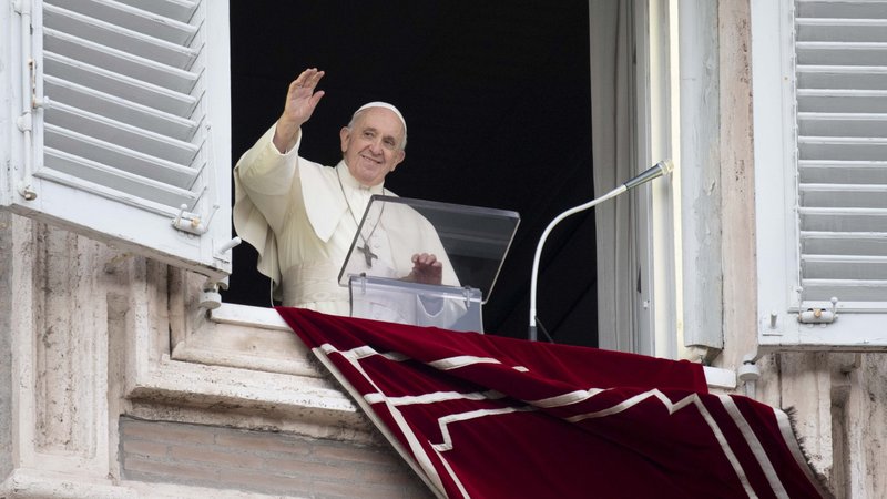 Pope Francis greets the crowd as he leads the Angelus from the window of his studio overlooking St. Peter's Square at the Vatican Nov. 1, 2021, the feast of All Saints. (CNS photo/Vatican Media)