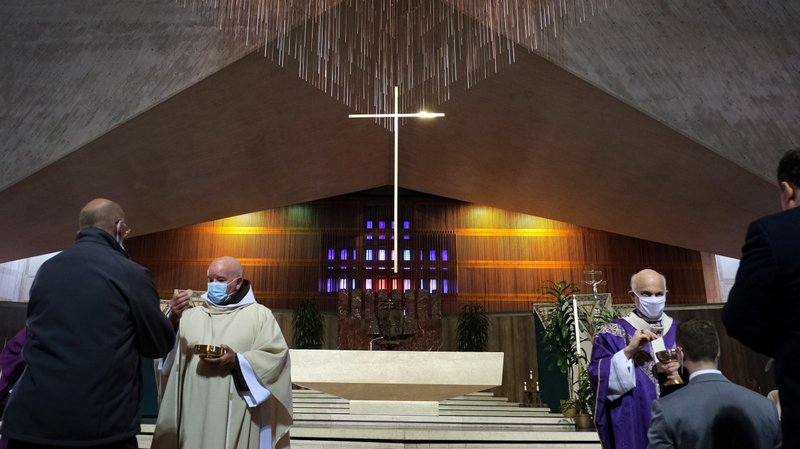 San Francisco Archbishop Salvatore J. Cordileone, right, distributes Communion during a Mass for the homeless at the Cathedral of St. Mary of the Assumption Nov. 6, 2021. The special Mass was part of archdiocese's "Year for the Homeless" launched in February. (CNS photo/David Maung)