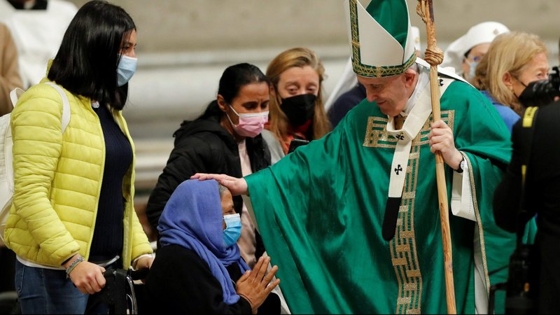 Pope Francis greets a woman as he leaves after celebrating Mass marking World Day of the Poor in St. Peter's Basilica at the Vatican Nov. 14, 2021. (CNS photo/Remo Casilli, Reuters)