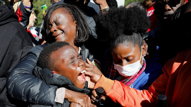 People in Brunswick, Ga., react outside the Glynn County Courthouse Nov. 24, 2021, after the jury reached a guilty verdict in the trial of William "Roddie" Bryan Jr., Travis McMichael and Gregory McMichael, charged with the February 2020 death of 25-year-old Ahmaud Arbery. (CNS photo/Marco Bello, Reuters)