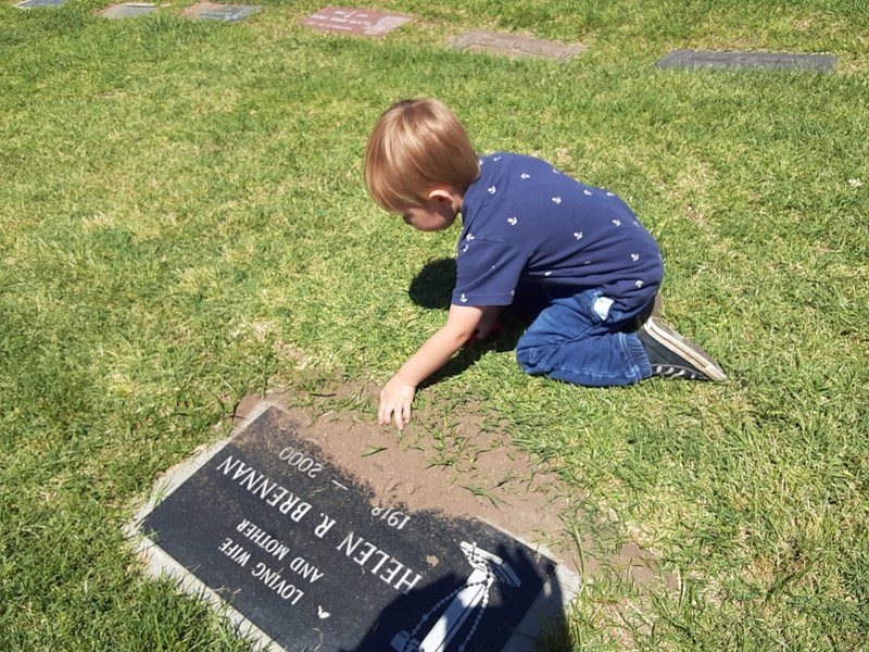 The author's grandson at the gravesite of his great-grandparents. (Robert Brennan)