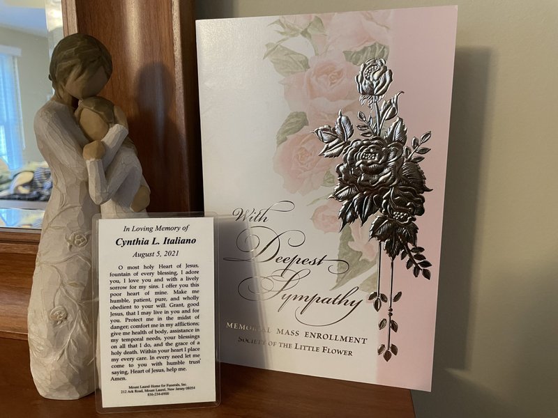 A prayer card remembering the author's mother with a Mass card for the repose of her soul.