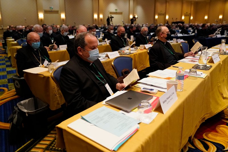 Bishop Manuel Cruz, front left, of Catholic Archdiocese of Newark, N.J., reads scripture during a morning prayer at the Fall General Assembly meeting of the United States Conference of Catholic Bishops, Wednesday, Nov. 17, 2021, in Baltimore.(Julio Cortez/AP via Crux)