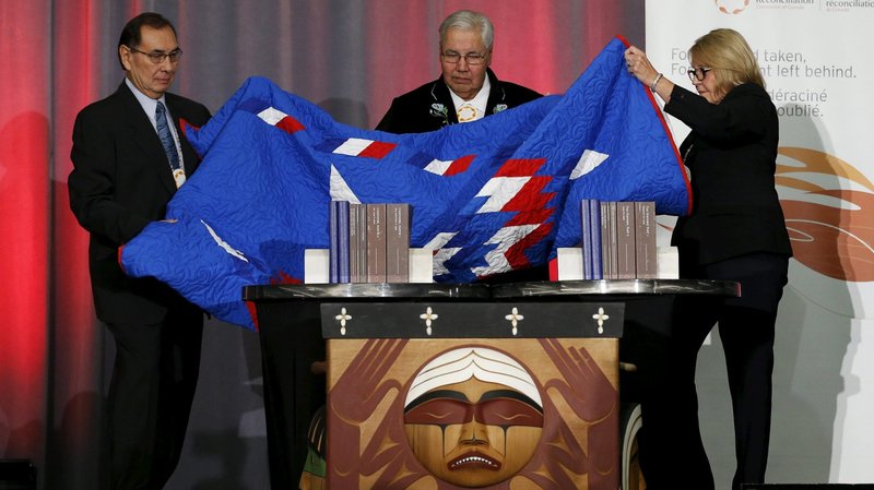 Cree Chief Wilton Littlechild, Justice Murray Sinclair and Commissioner Marie Wilson unveil the Truth and Reconciliation Commission's final report in Ottawa, Ontario, Dec. 15, 2015. One of the Calls to Action in the report was a papal apology -- in Canada -- for church leaders' past treatment of Indigenous Canadians. (CNS photo/Chris Wattie, Reuters)