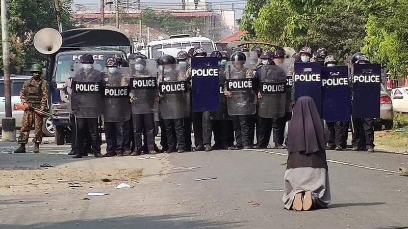 Sister Ann Rose Nu Tawng, a member of the Sisters of St. Francis Xavier, kneels in front of police and soldiers during an anti-coup protest in Myitkyina, Myanmar, Feb. 28, 2021. Sister Tawng, who became a symbol of Myanmar's nationwide protests, has been named by the BBC as among the 100 most influential and inspiring women of the year. (CNS photo/courtesy Myitkyina News Journal)