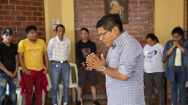Abraham Luque, a catechist from the Scalabrinian Parish of Our Lady of the Perpetual Help, prays during a Christmas event at the Scalabrini welcome center in Lima, Peru, in this Dec. 16, 2018, file photo. In May 2021 formally instituted the ministry of catechist. (CNS photo/Oscar Durand)