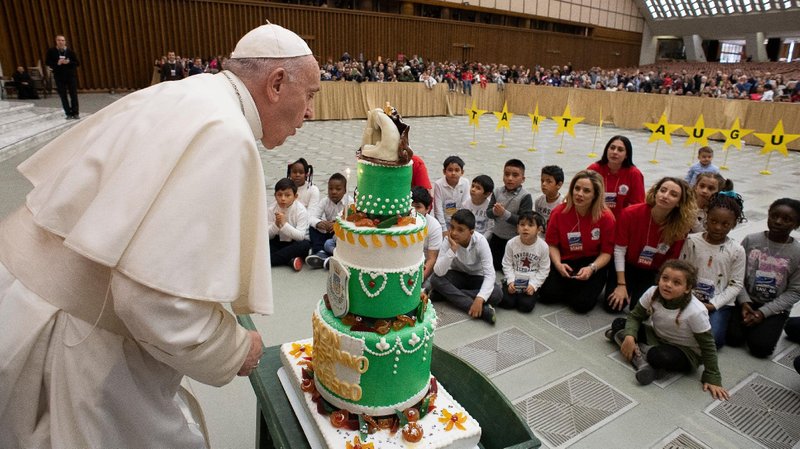 Pope Francis blows out the candle on a cake made for his Dec. 17 birthday during a special pre-Christmas meeting with children at the Vatican in this Dec. 22, 2019, file photo. The pope will celebrate his 85th birthday Dec. 17 and, according to his nephew, Jesuit Father José Luis Narvaja, he is still energetic and rarin' to go. (CNS photo/Vatican Media)