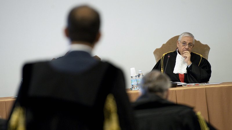 Vatican judge Giuseppe Pignatone listens during the third session of the trial of six defendants accused of financial crimes, at the Vatican City State criminal court in this Nov. 17, 2021, file photo. At the fifth session of the Vatican trial Dec. 14, Pignatone said the complicated case was "a construction site" and expressed his hope that by mid-February the trial would begin to focus on the key accusations. (CNS photo/Vatican Media)