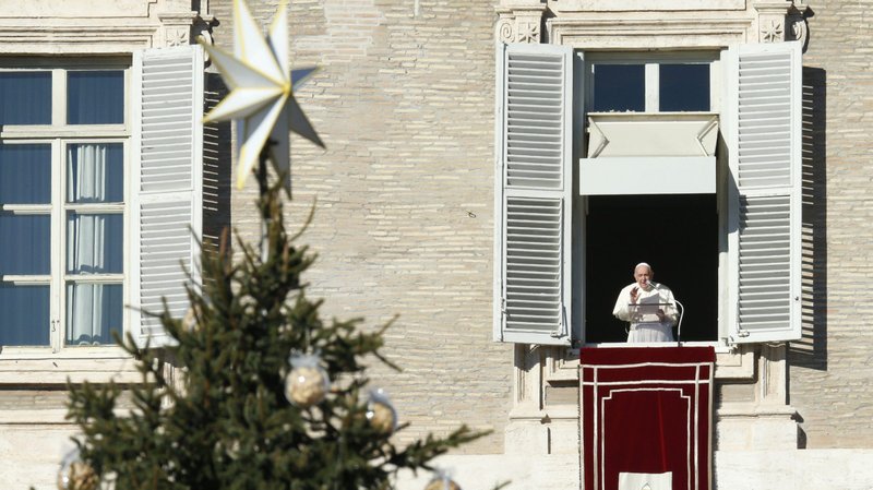 The Christmas tree is seen as Pope Francis leads the Angelus from the window of his studio overlooking St. Peter's Square at the Vatican Dec. 19, 2021. (CNS photo/Paul Haring)