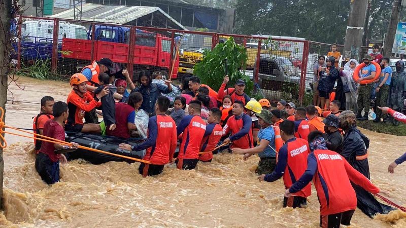 Philippine Coast Guard personnel rescue residents stranded by floods caused by Typhoon Rai in Cagayan de Oro, Philippines, Dec. 16, 2021. The storm has claimed more than 200 lives and Caritas Philippines has appealed for donations to bolster its emergency response. (CNS photo/Philippine Coast Guard handout via Reuters)