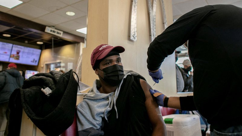 A man in Chicago receives a COVID-19 booster shot at a McDonald's Dec. 21, 2021. The federal Centers for Disease Control and Prevention reported Dec. 20 that the omicron variant is now the dominant version of the coronavirus in the United States. (CNS photo/Jim Vondruska, Reuters)