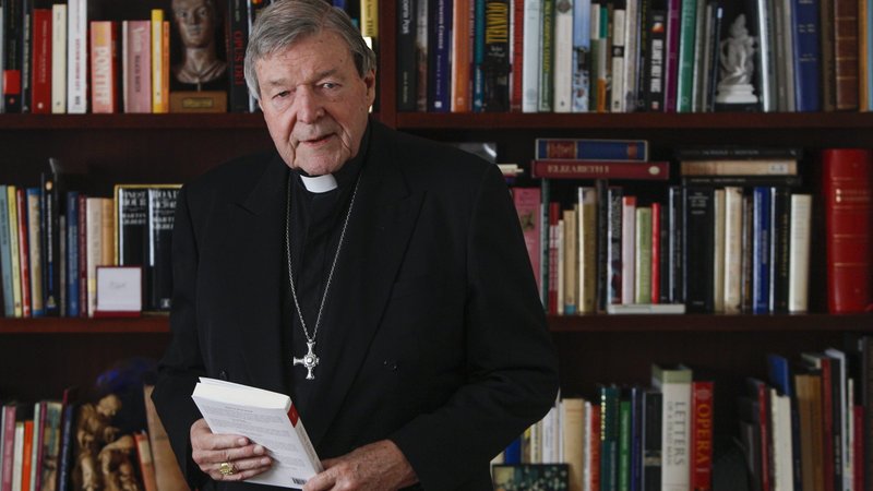 Australian Cardinal George Pell holds a copy of his book, "Prison Journal," during an interview at his residence in Rome on Dec. 18, 2020. (CNS/Robert Duncan)