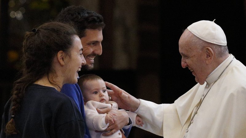 Pope Francis greets a family during a meeting with the poor at the Basilica of St. Mary of the Angels in Assisi, Italy, Nov. 12, 2021. During his Dec. 26 Angelus, the pope said as a "Christmas gift" he had written a letter to families. (CNS/Paul Haring)