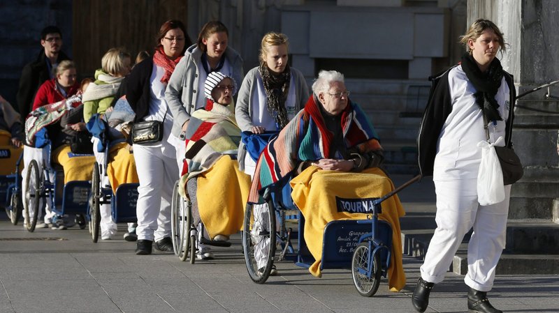 Caregivers push the sick and disabled at the Shrine of Our Lady of Lourdes in southwestern France in this May 16, 2014, file photo. In a message for the Feb. 11 World Day of the Sick, Pope Francis emphasized a patient-centered approach to medical care. (CNS photo/Paul Haring)