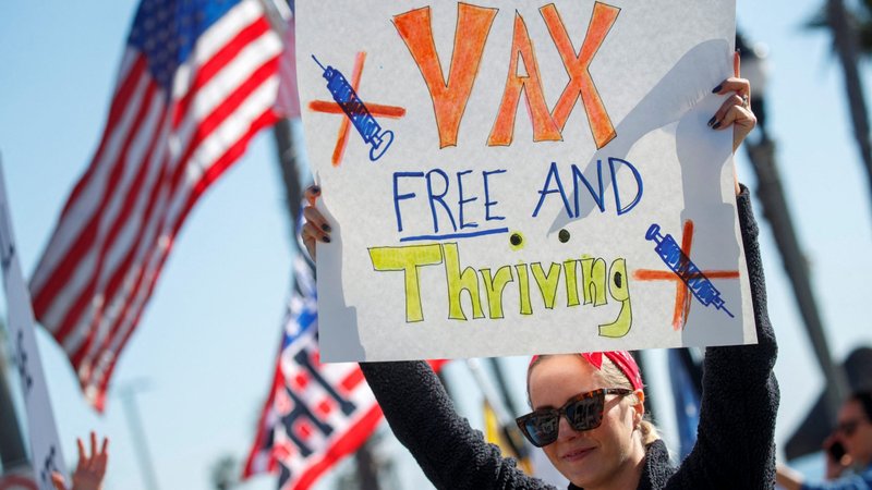 A woman in Huntington Beach, Calif., holds a sign during a protest about the COVID-19 vaccine mandates for school children and workers Jan. 3, 2022. The Supreme Court heard arguments Jan. 7 about the legality of the Biden administration's efforts to address the coronavirus pandemic with workplace vaccine mandates. (CNS photo/Mike Blake, Reuters)
