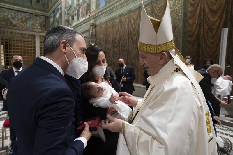 Pope Francis greets the parents of a newly baptized baby after celebrating Mass marking the feast of the Baptism of the Lord in the Sistine Chapel at the Vatican on Jan. 9. (CNS photo/Vatican Media)