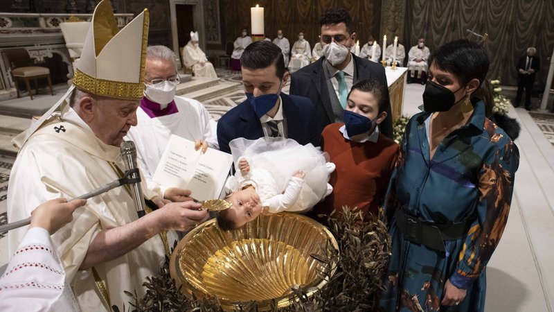 Pope Francis baptizes a baby during Mass marking the feast of the Baptism of the Lord in the Sistine Chapel at the Vatican Jan. 9, 2022. The pope baptized 16 infants. (CNS photo/Vatican Media)